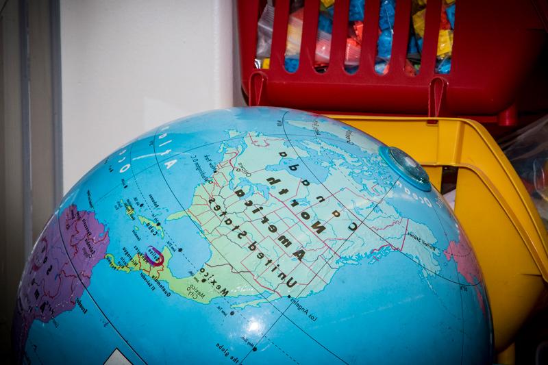 Close up picture of a globe in a classroom.