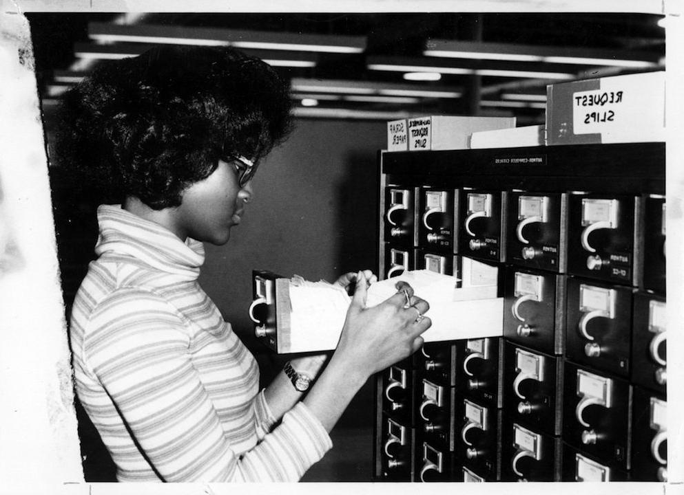 Student searching for a text in MSU Denver's first library