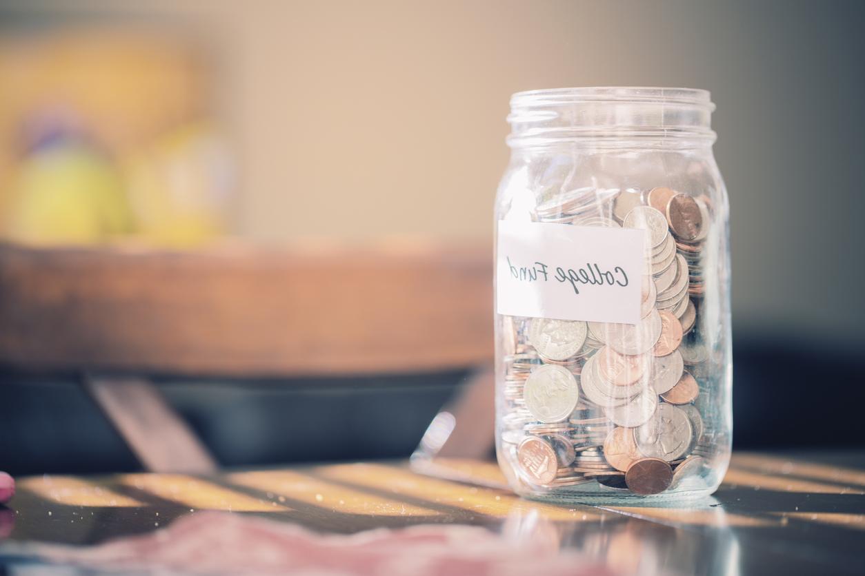 A Mason Jar full of coins marked with the words 