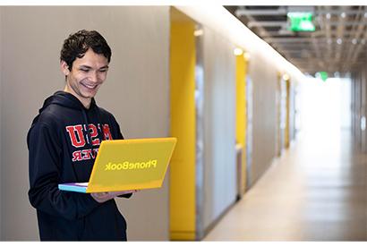 Dominique Hunt holding a yellow laptop