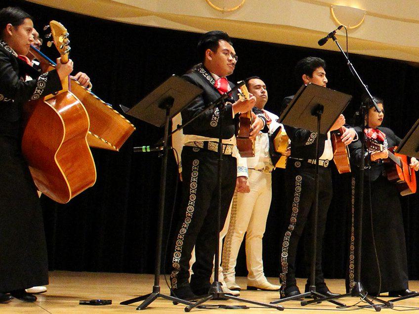 mariachi performers standing on a stage