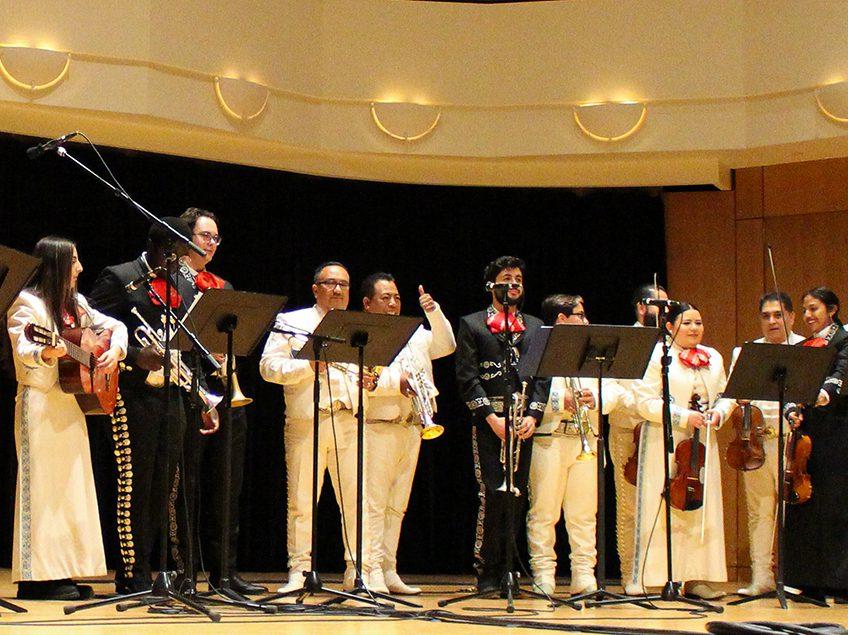 mariachi performers standing on a stage